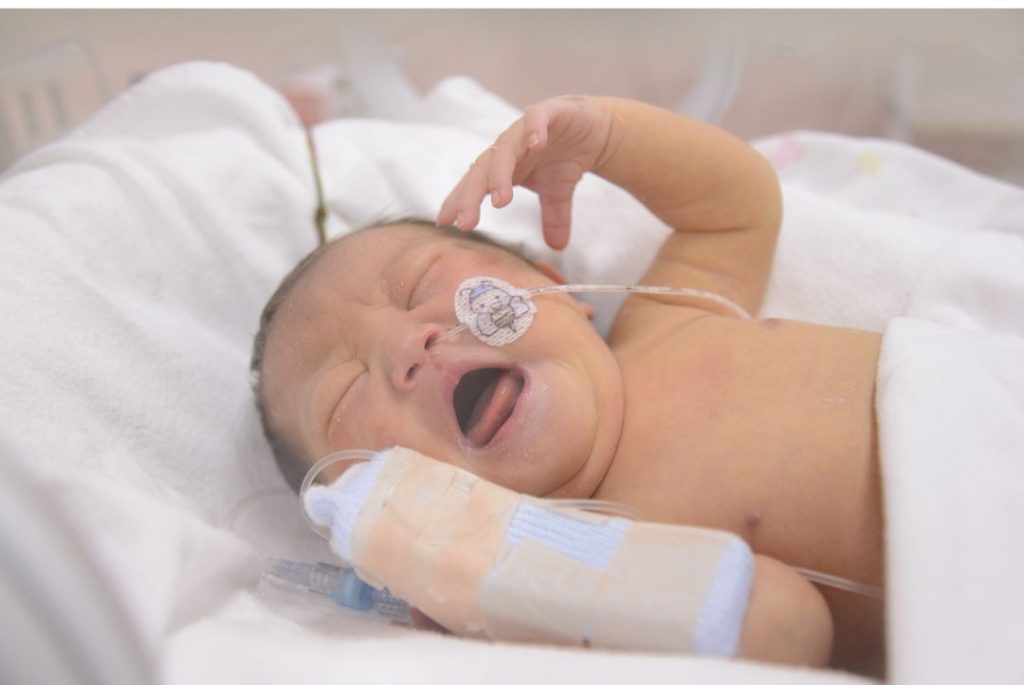 Birth mother bonding with her baby in the NICU