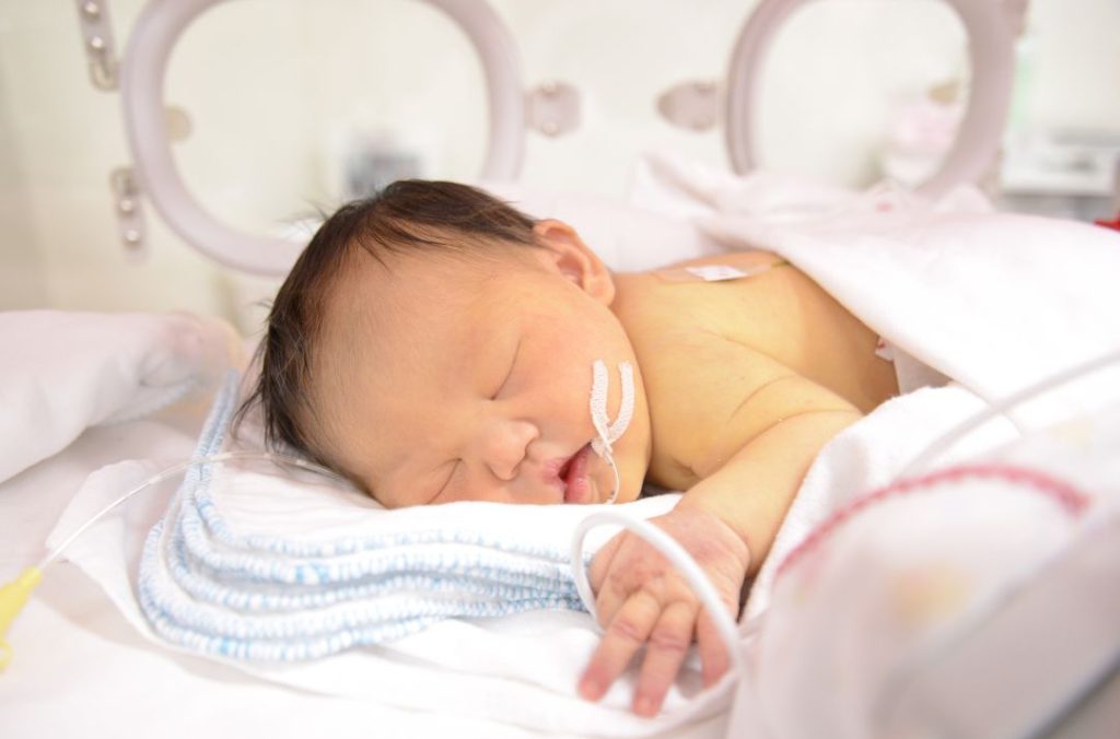 Birth mother bonding with her baby in the NICU