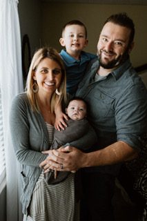 Alison and her husband with their new baby