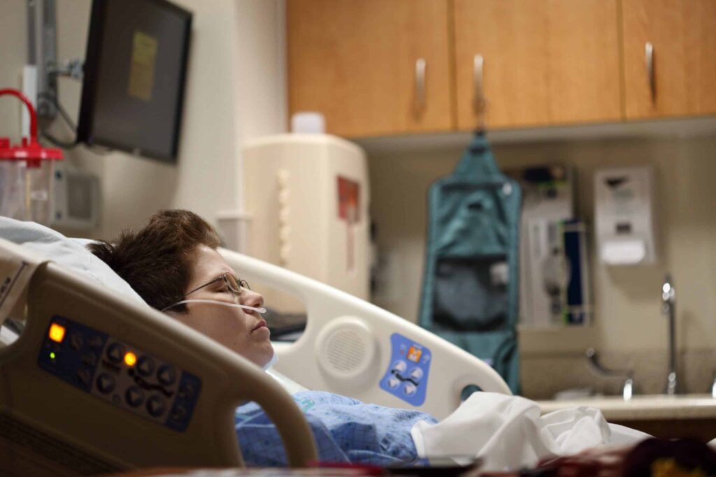A woman resting in a hospital bed