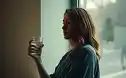 An expectant mother by a window