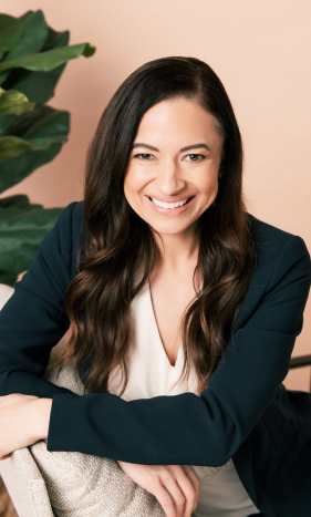 Cherie smiling in a dark blazer