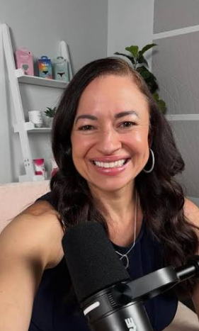 Cherie recording at a podcast microphone